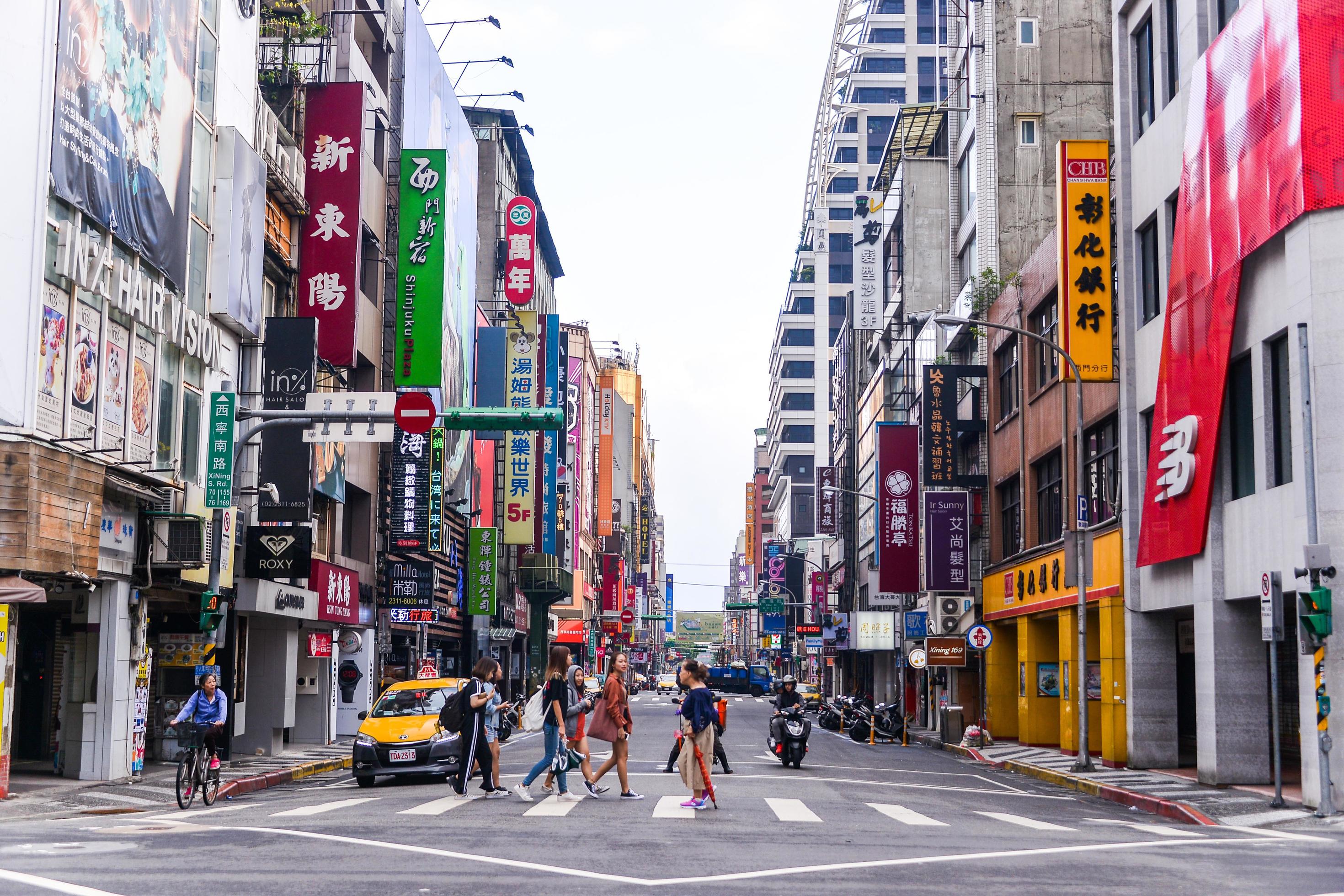 Taipei street scene with dense storefront signs and pedestrians